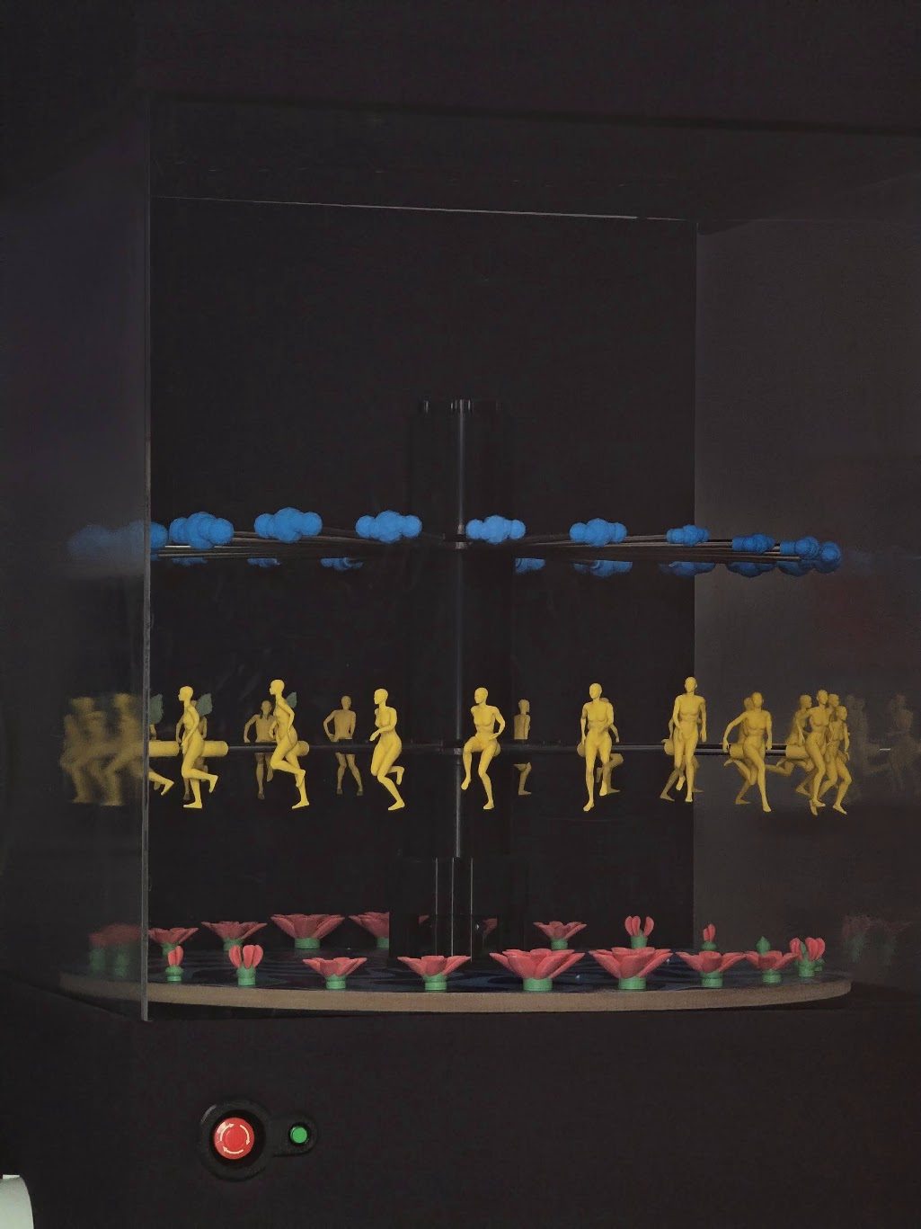The same piece with the room lights off and the platter stopped, the three layers reading as three separate horizontal bands of clouds, figures and lotuses